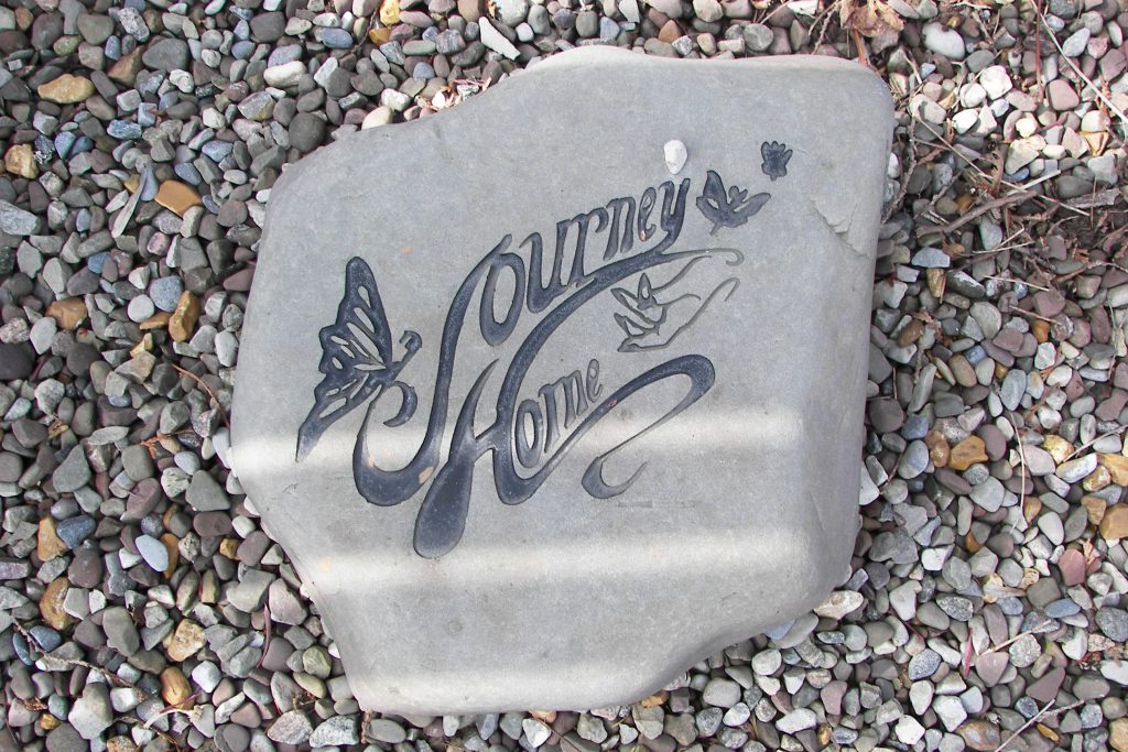 Decorative stone with 'Journey Home' engraving