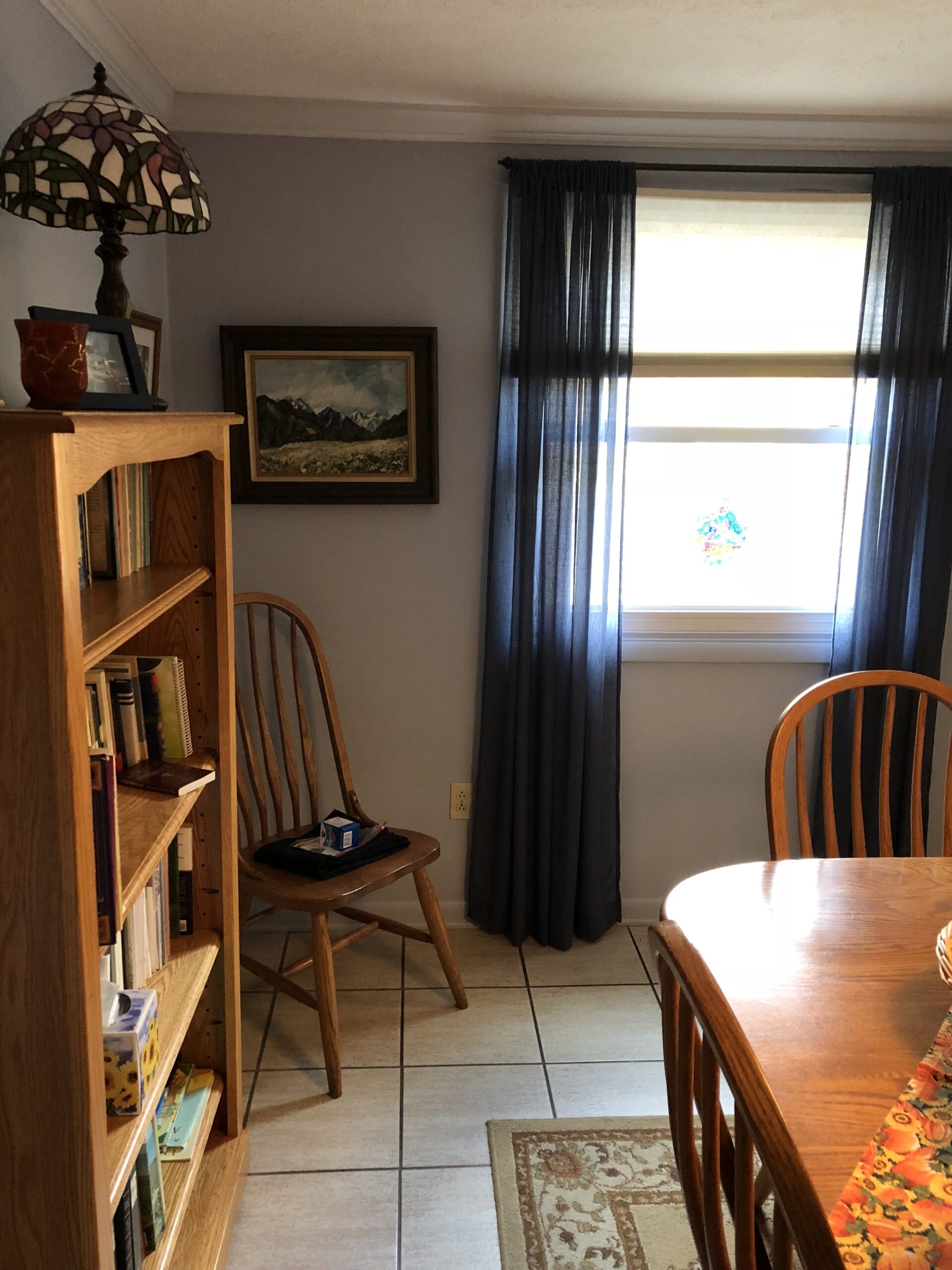 Cozy common area with bookshelves and a lamp.