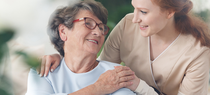 Caregiver and resident sharing a joyful moment