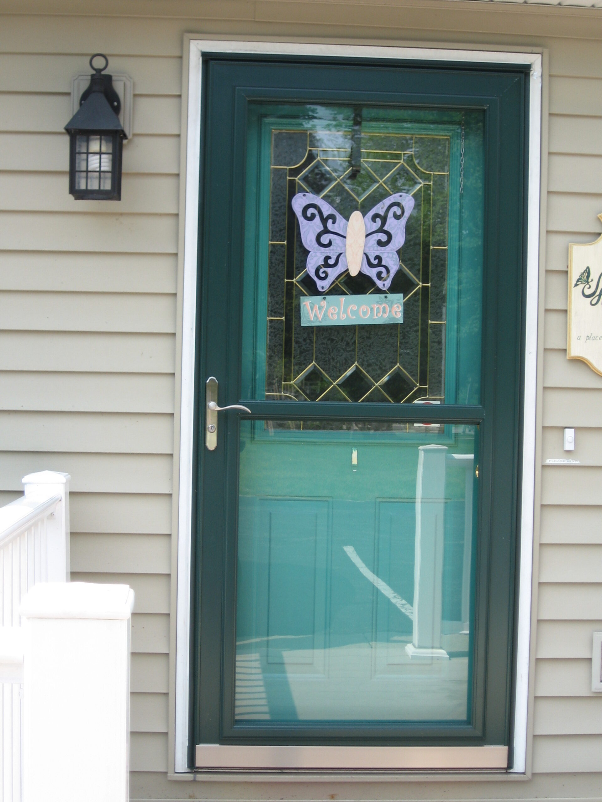Welcome door with a butterfly design.