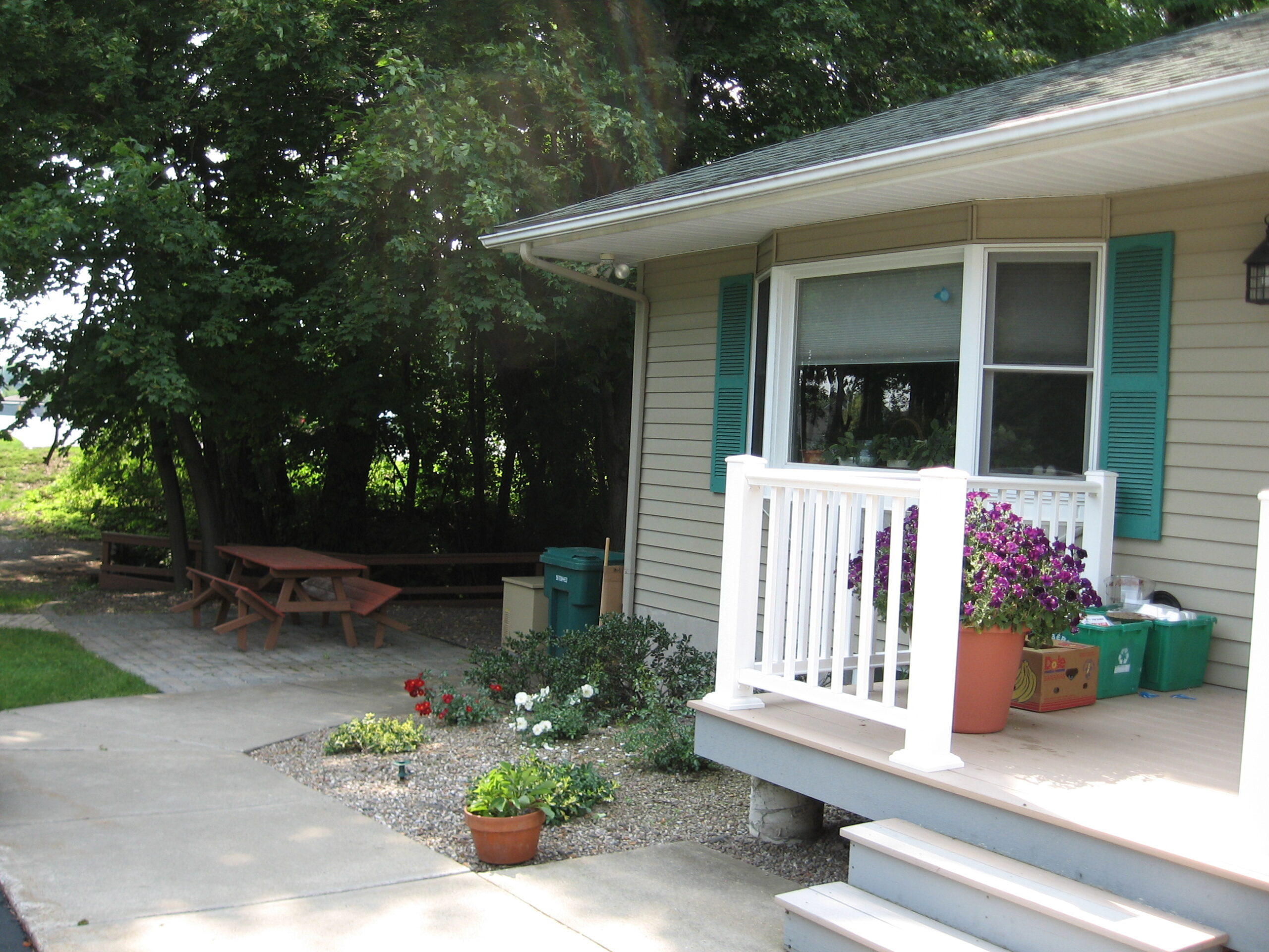 Exterior view of a porch with flowers and seating