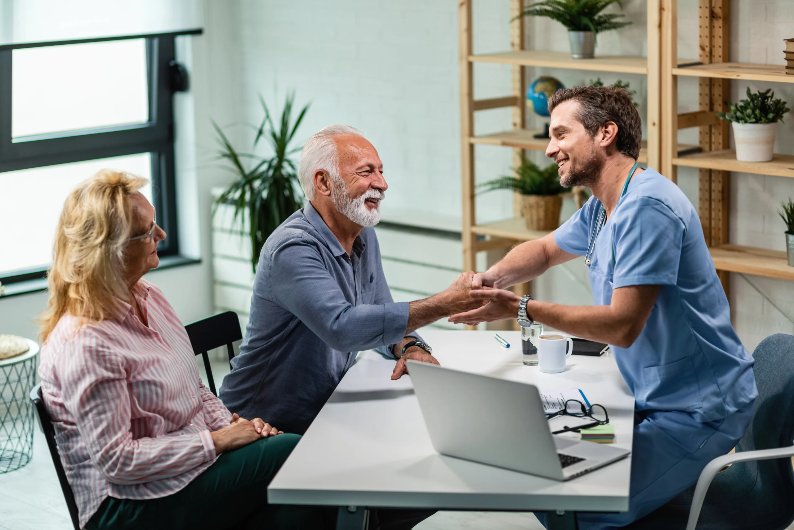 Residents talking with a staff member in a common area.