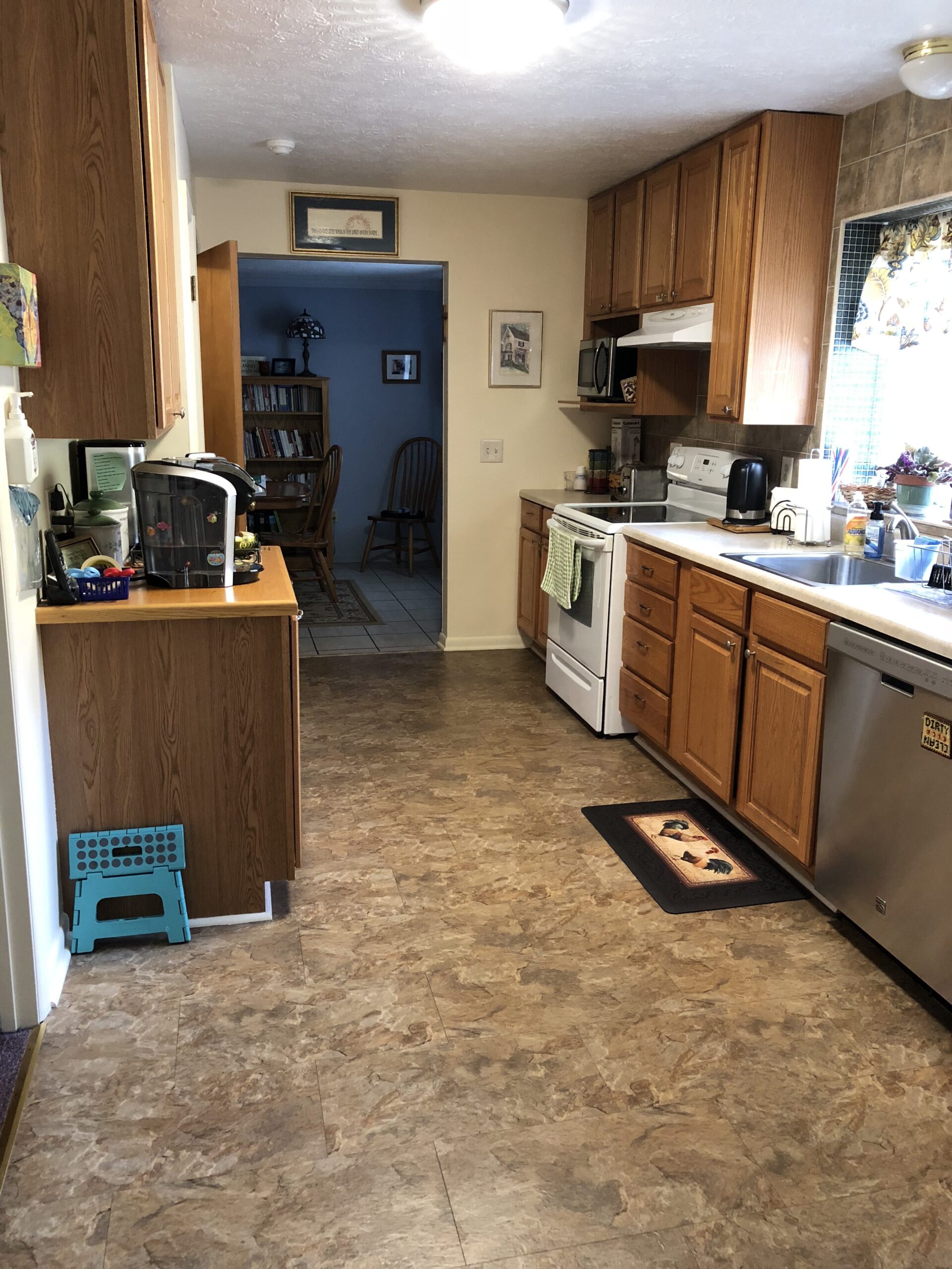 Well-lit kitchen area with wooden cabinets.