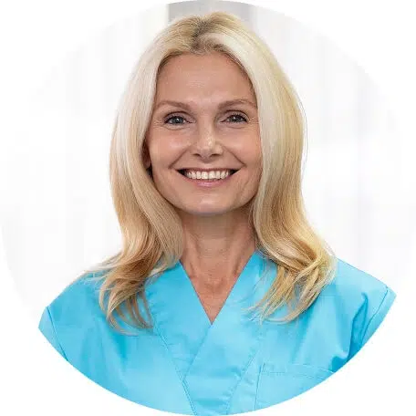 Smiling staff member in a blue uniform