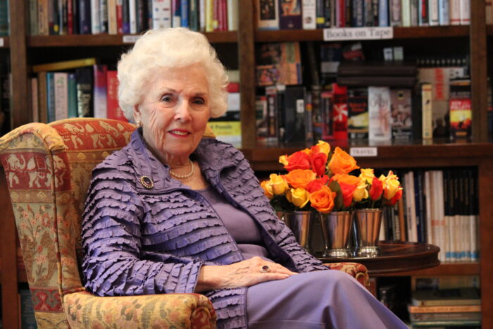 Resident posing in a cozy library setting