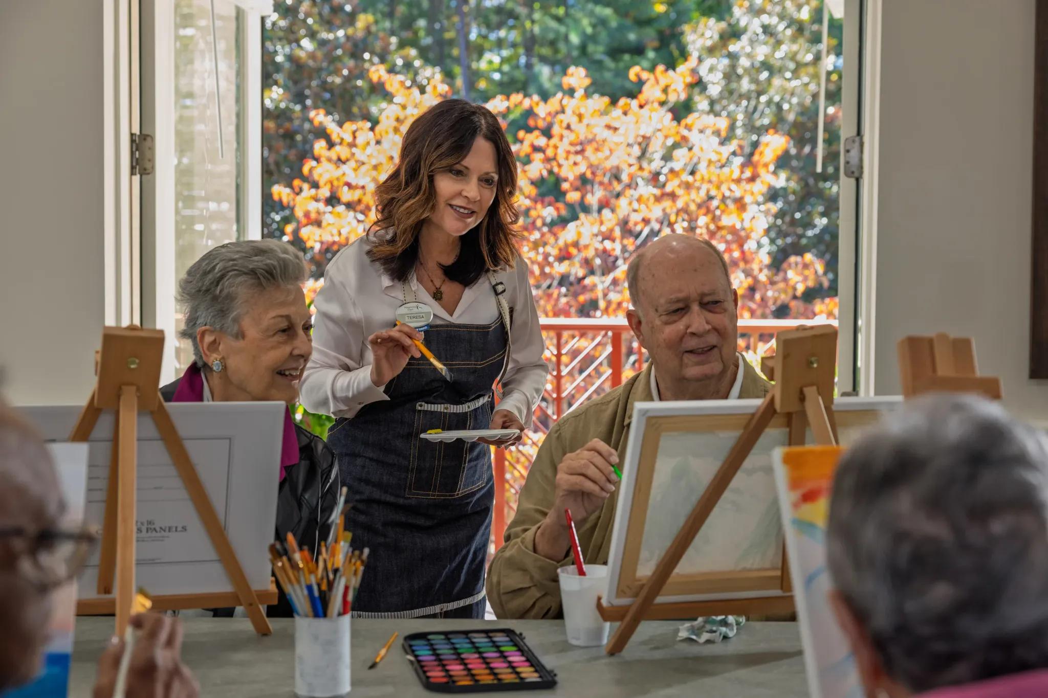 Residents painting during an art activity with staff