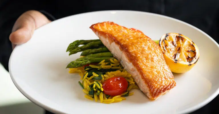 A plated meal featuring salmon and asparagus