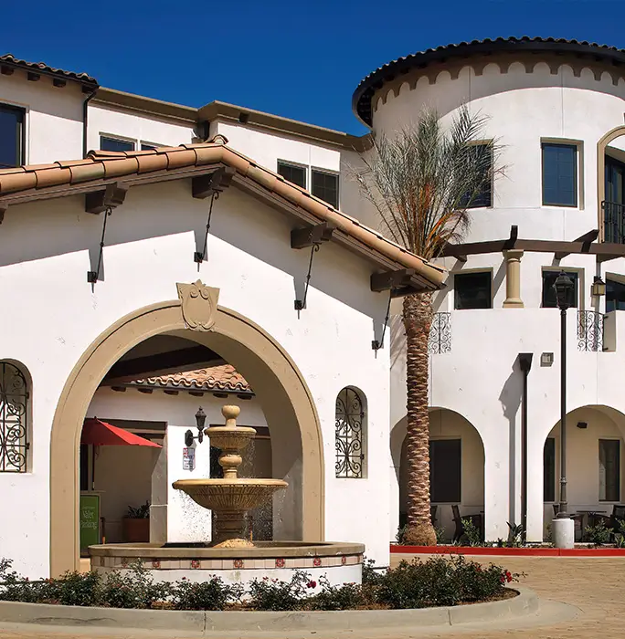 Exterior view of a senior living facility with a fountain