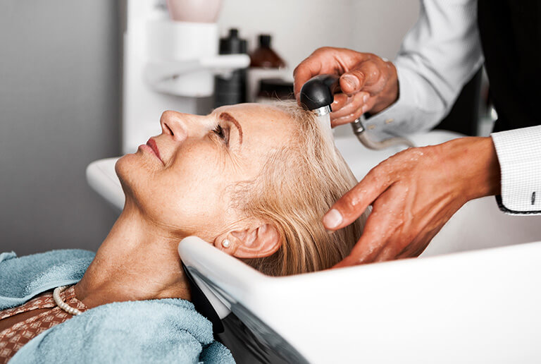Resident receiving a hair wash during a spa treatment
