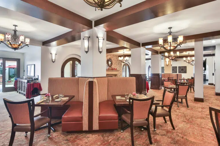 Dining area with tables and chairs set for meals