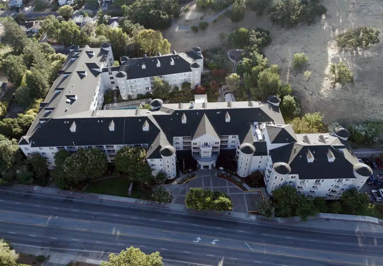Aerial view of a senior living facility with landscaped grounds
