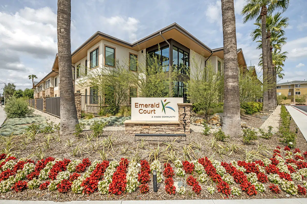Exterior view of Emerald Court community with flowers