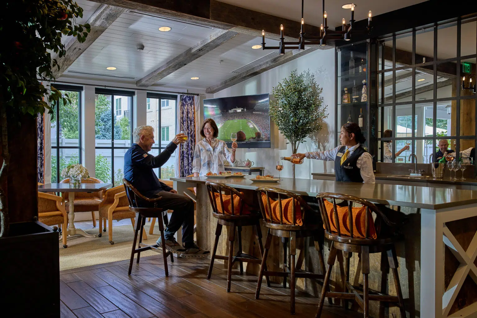 Residents enjoying drinks at a stylish bar area