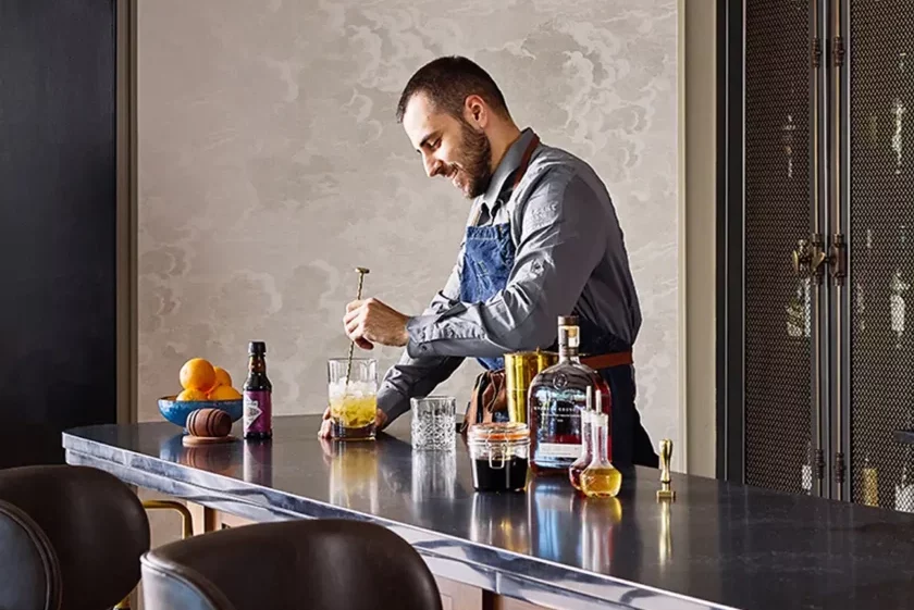 A person making a drink at a modern counter