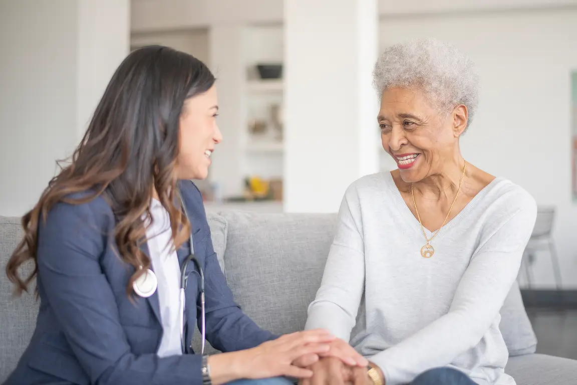 Healthcare professional engaging with a happy senior resident