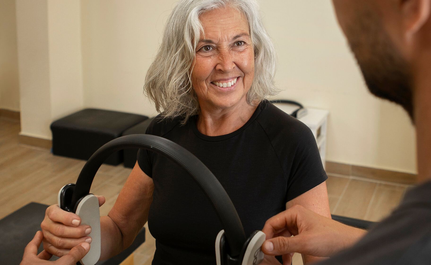 Resident engaging in an exercise activity with staff assistance