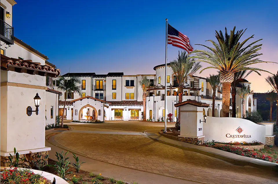 Entrance to Crestvilla assisted living facility with palm trees