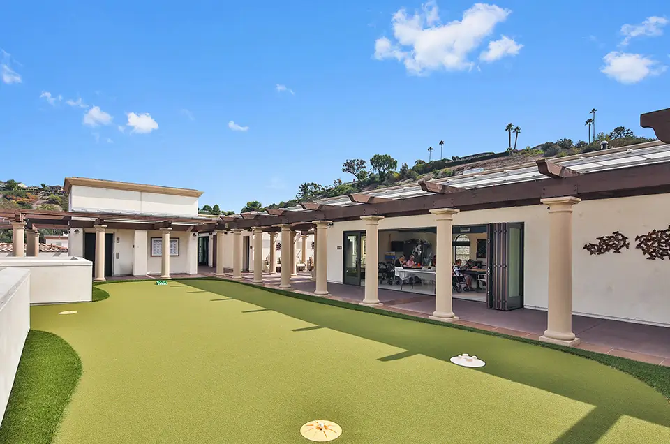Outdoor social area with residents and lawn