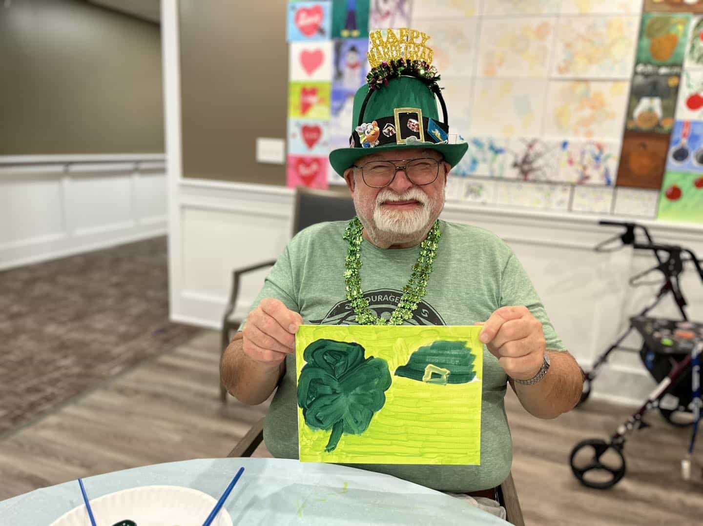 Senior resident showing off artwork during a celebration