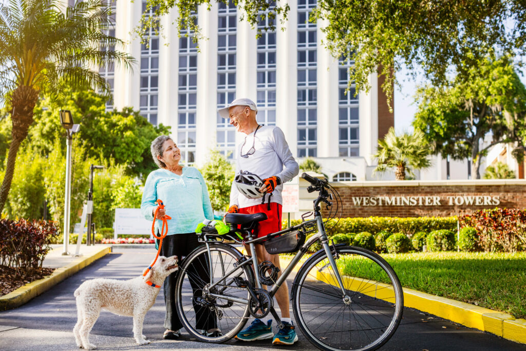 Two residents enjoying the outdoor space in front of the facility