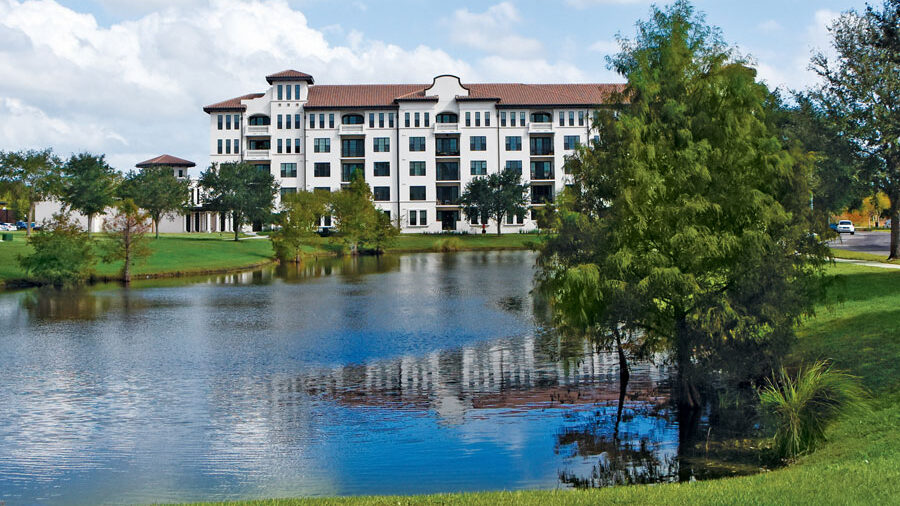 Exterior view of Westminster Towers near a pond