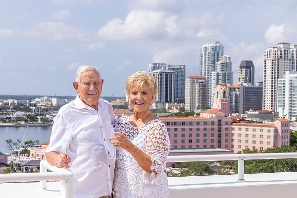 Elderly couple enjoying a sunny day on a balcony