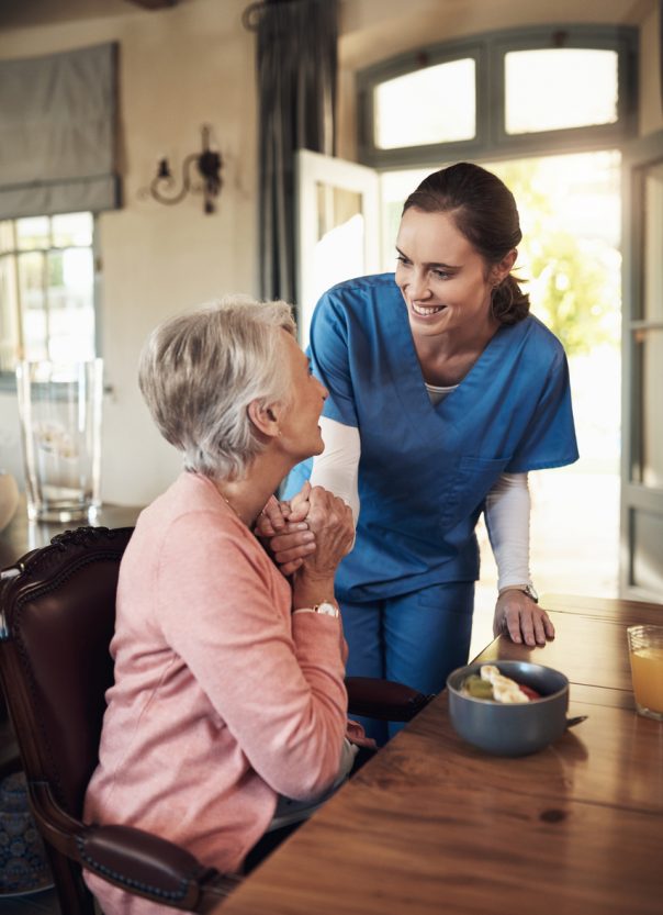 Caregiver interacting warmly with a senior resident
