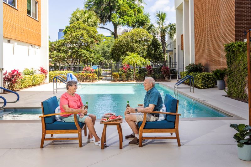 Residents enjoying drinks by the poolside