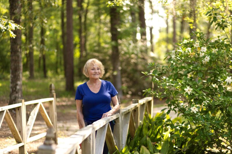 Woman enjoying a peaceful outdoor space with flowers