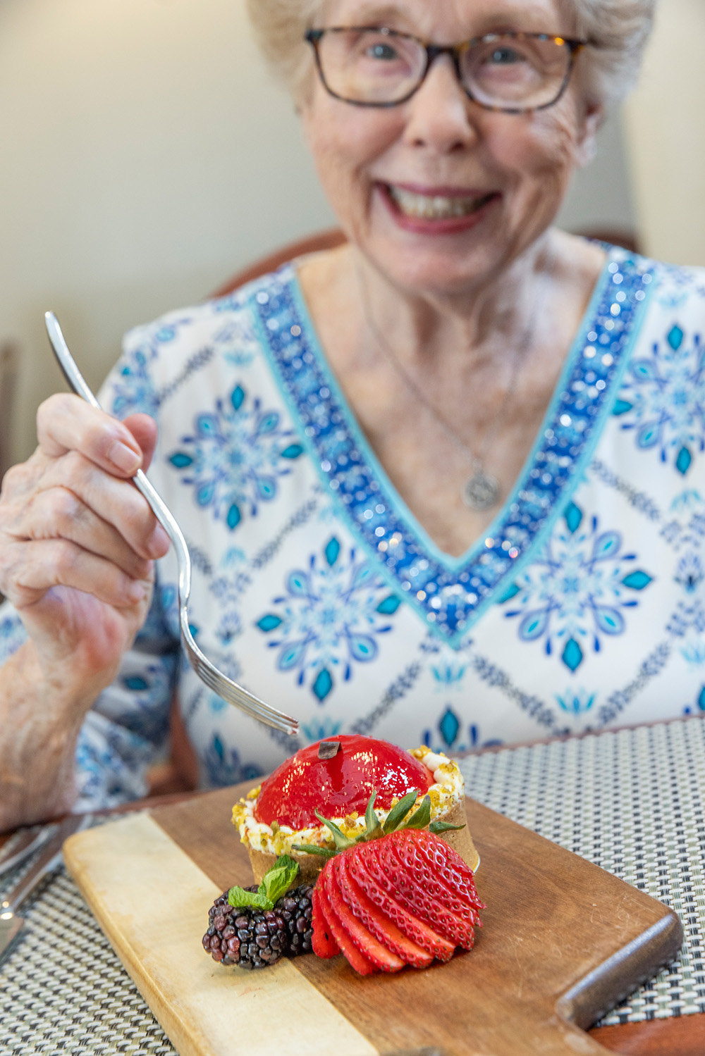 Resident enjoying a dessert in a dining setting
