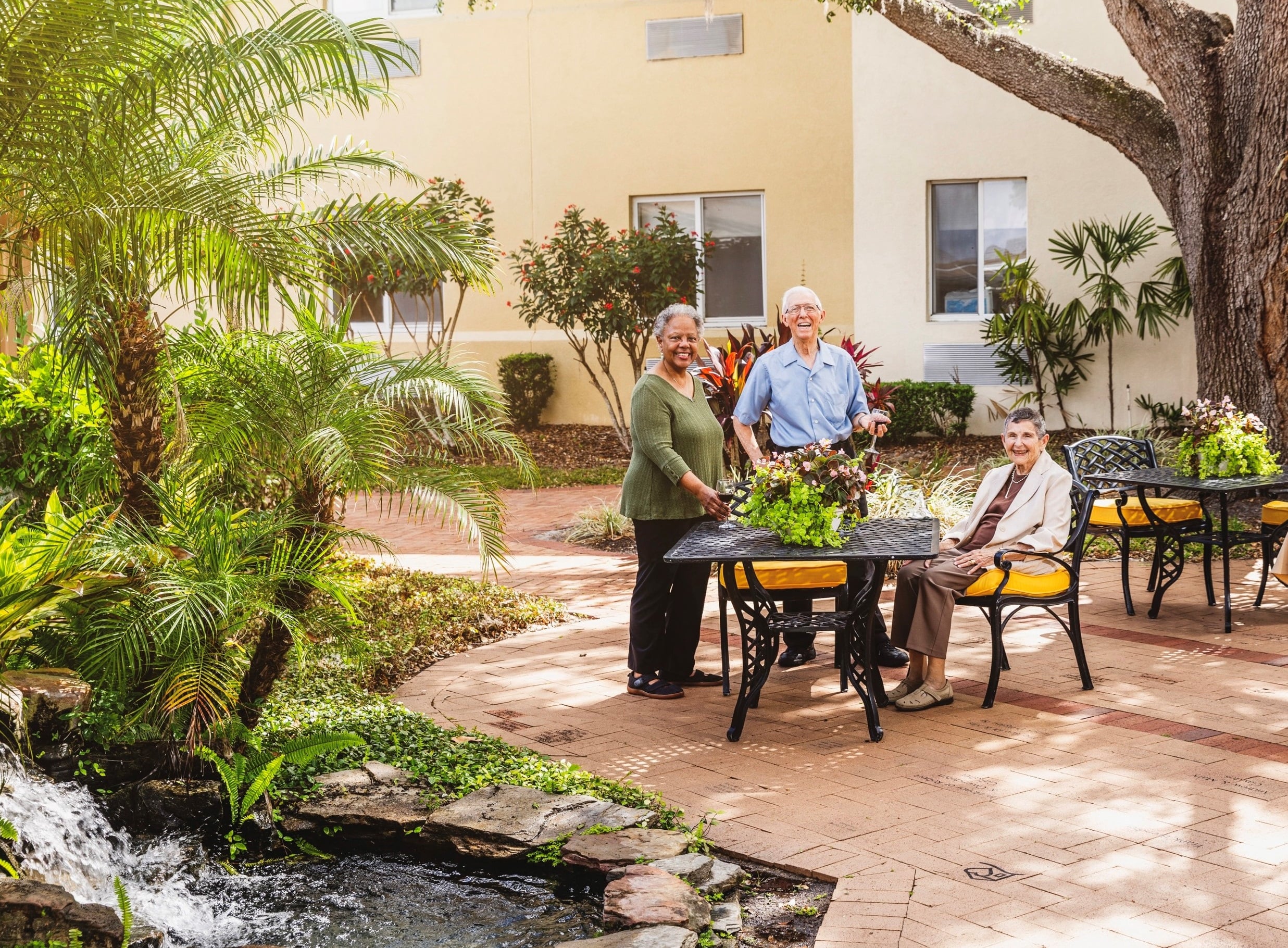 Residents enjoying a sunny outdoor space with plants