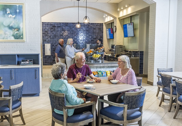 Residents enjoying dessert in a dining area