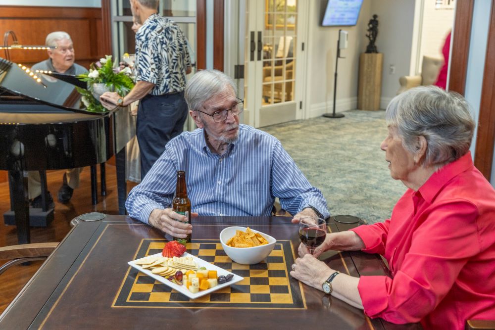 Residents enjoying snacks and conversation in a common area