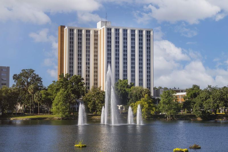 Exterior view of Westminster Towers by the lake with fountains