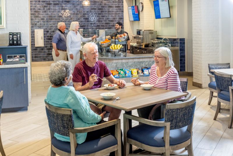 Residents enjoying snacks in a dining area