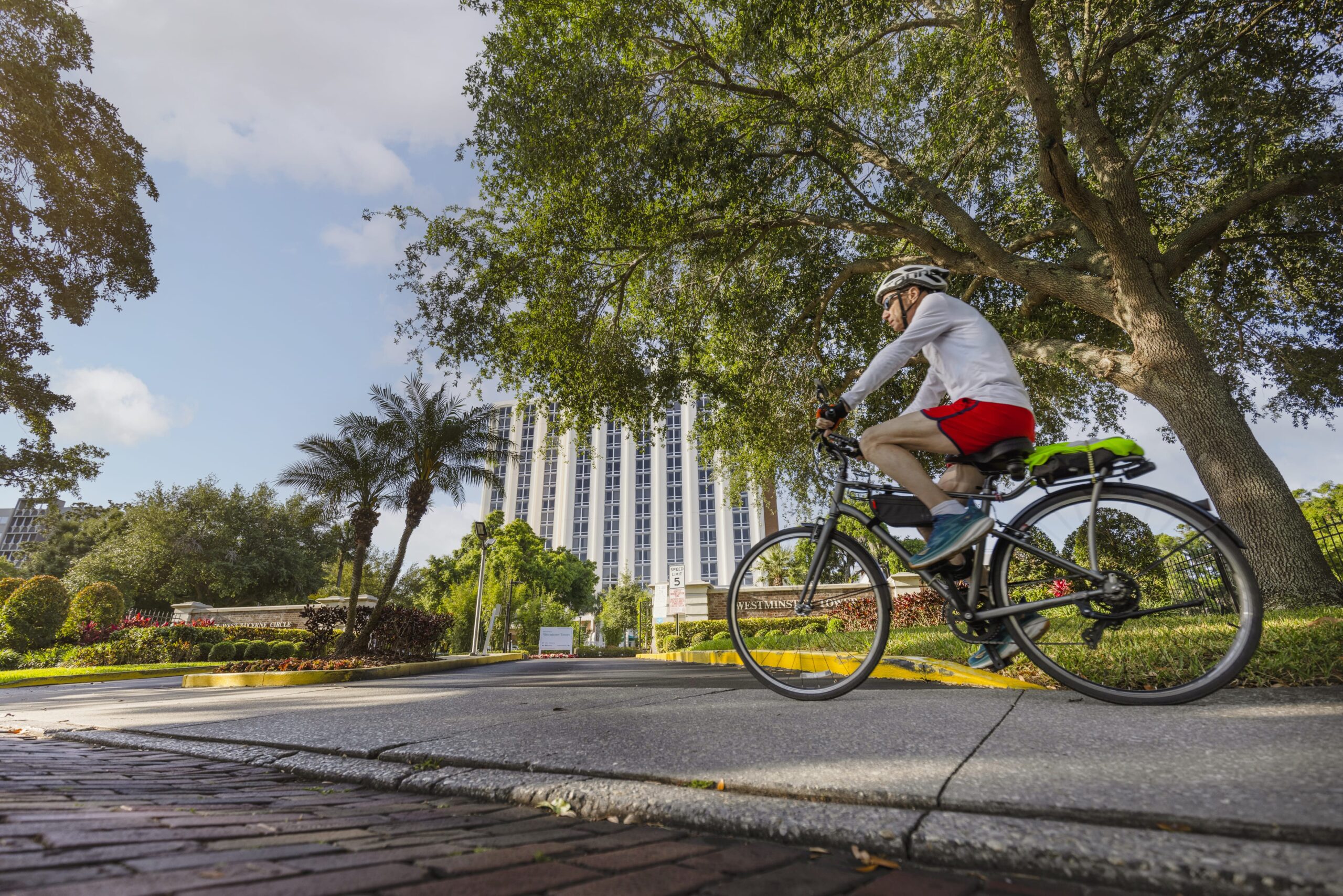 A resident cycling on a path near the facility building