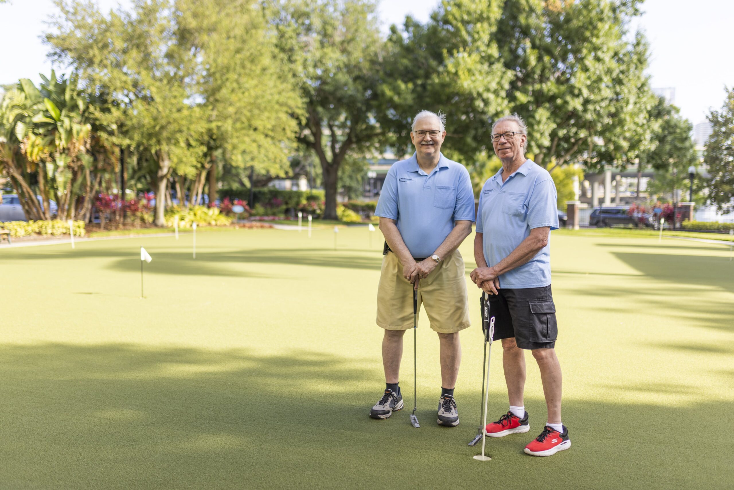 Two residents enjoying outdoor putting green