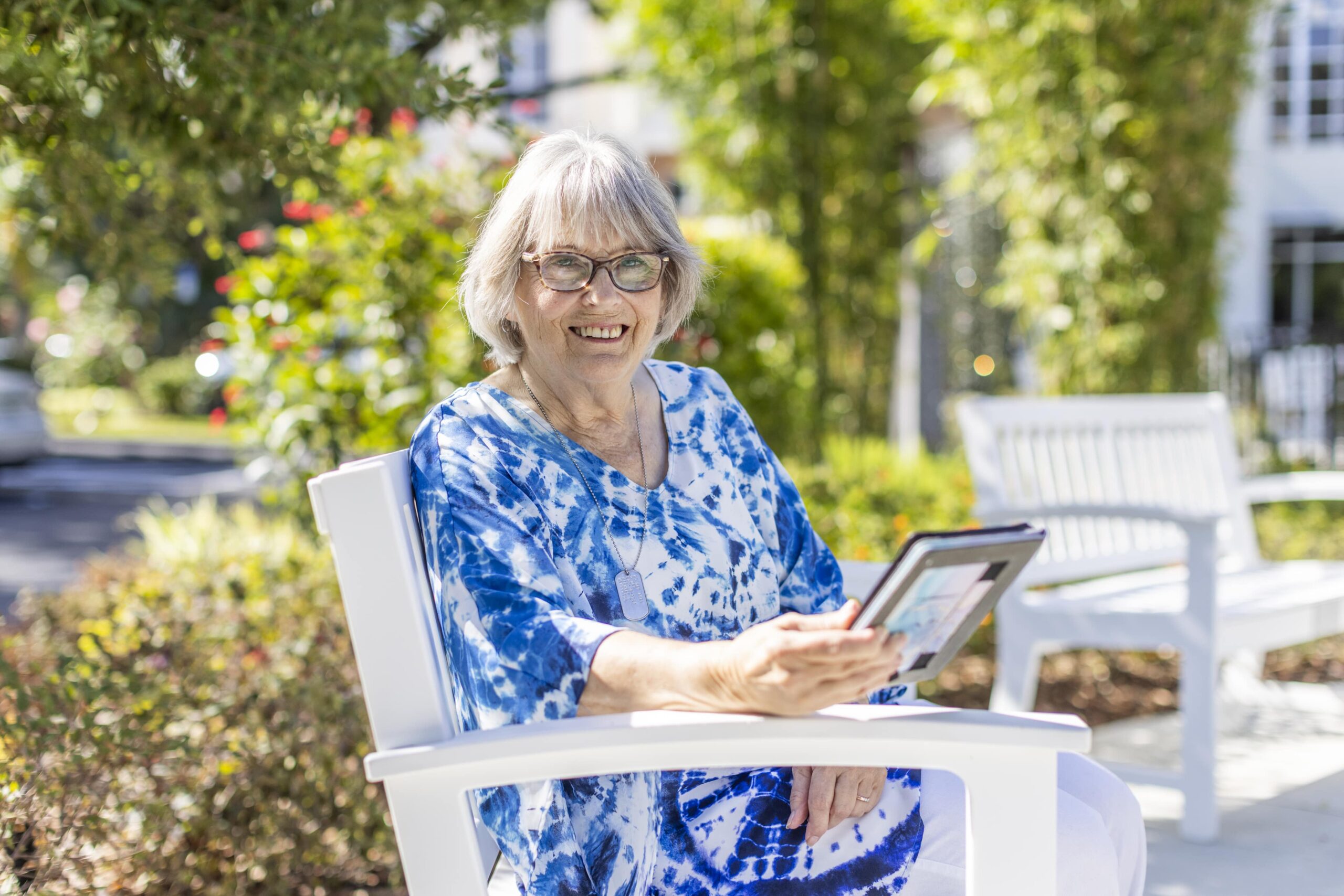 A resident enjoying the outdoors with a tablet