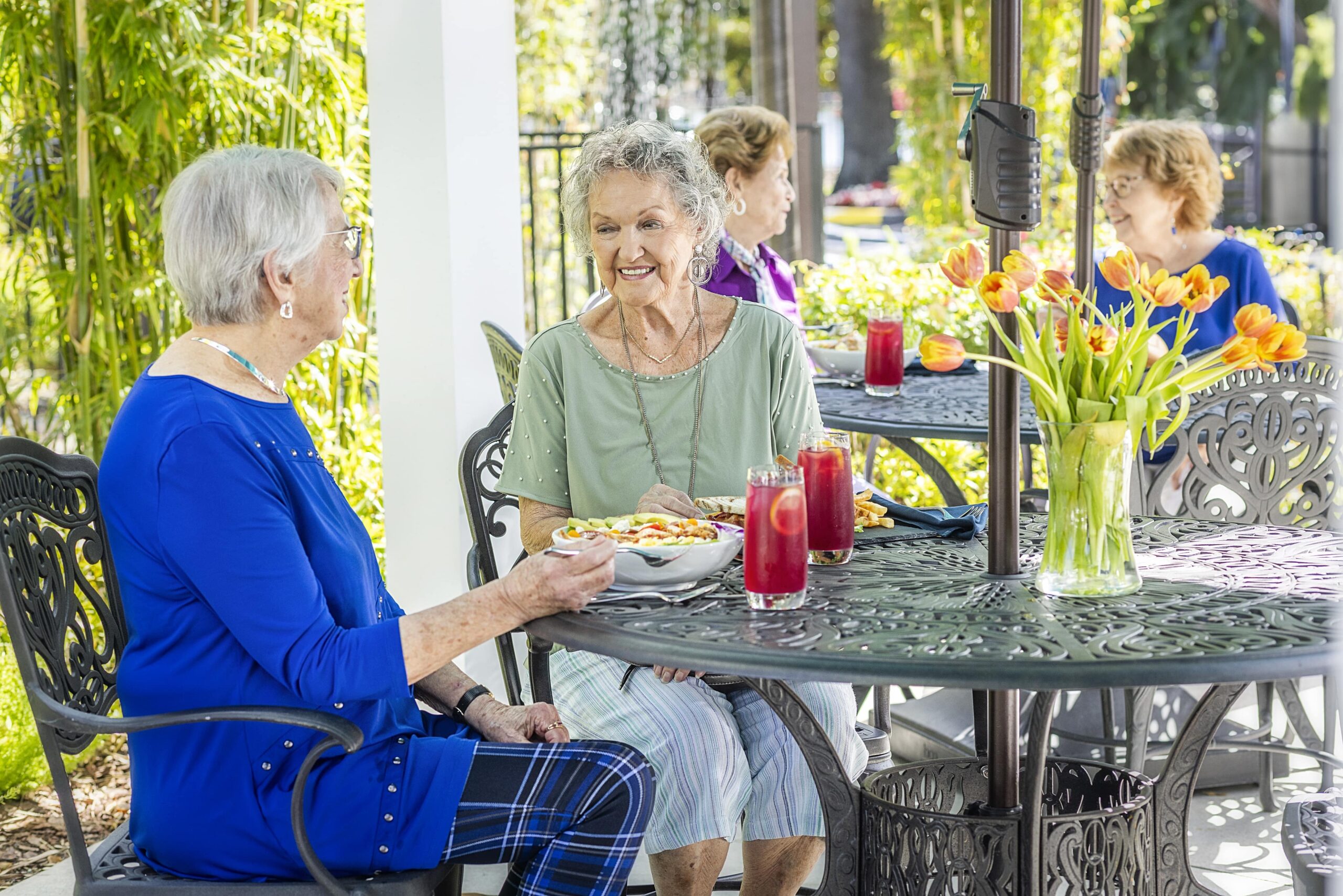 Residents enjoying lunch outside on a patio