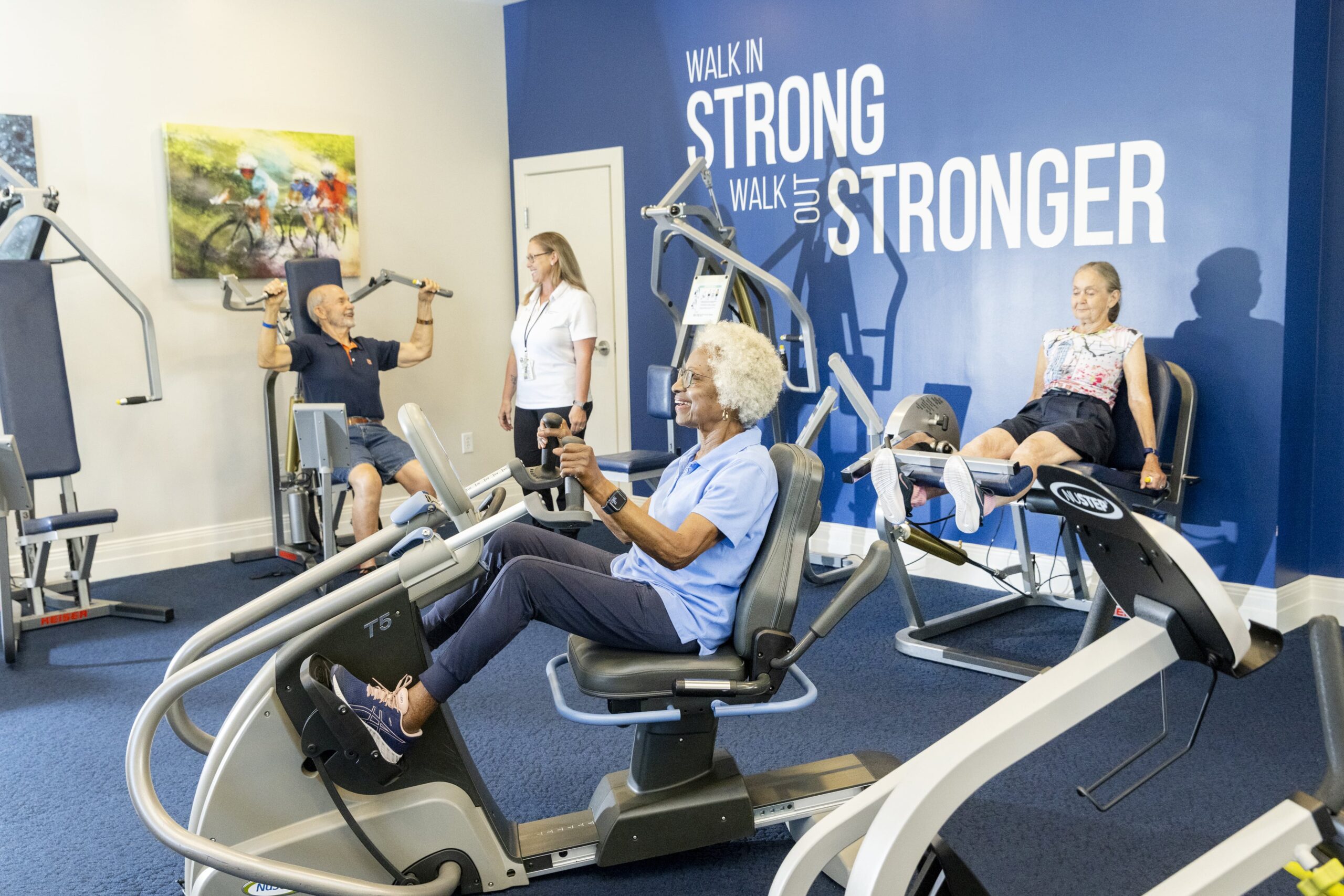 Residents exercising in a well-equipped gym