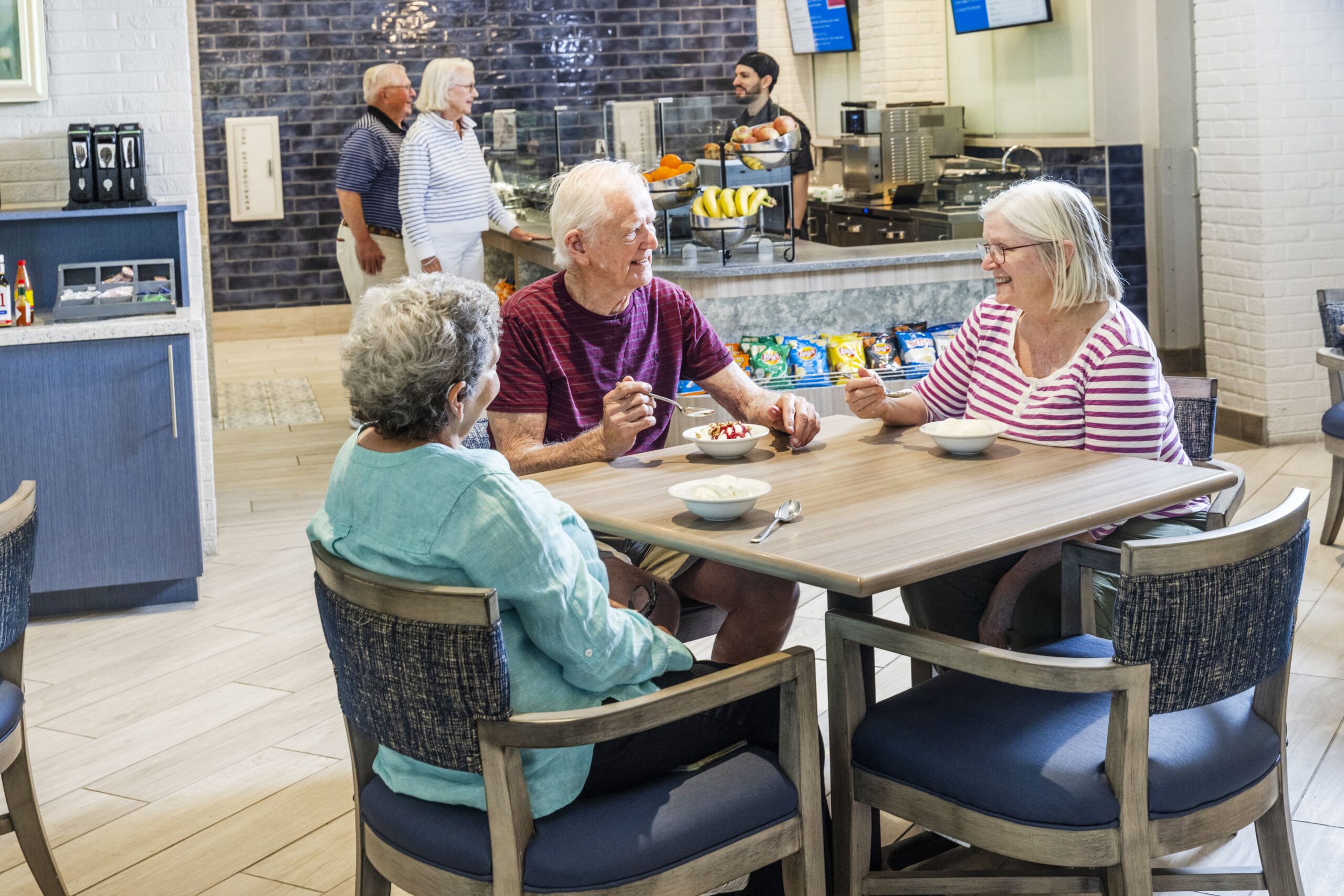 Residents enjoying dessert in a dining area