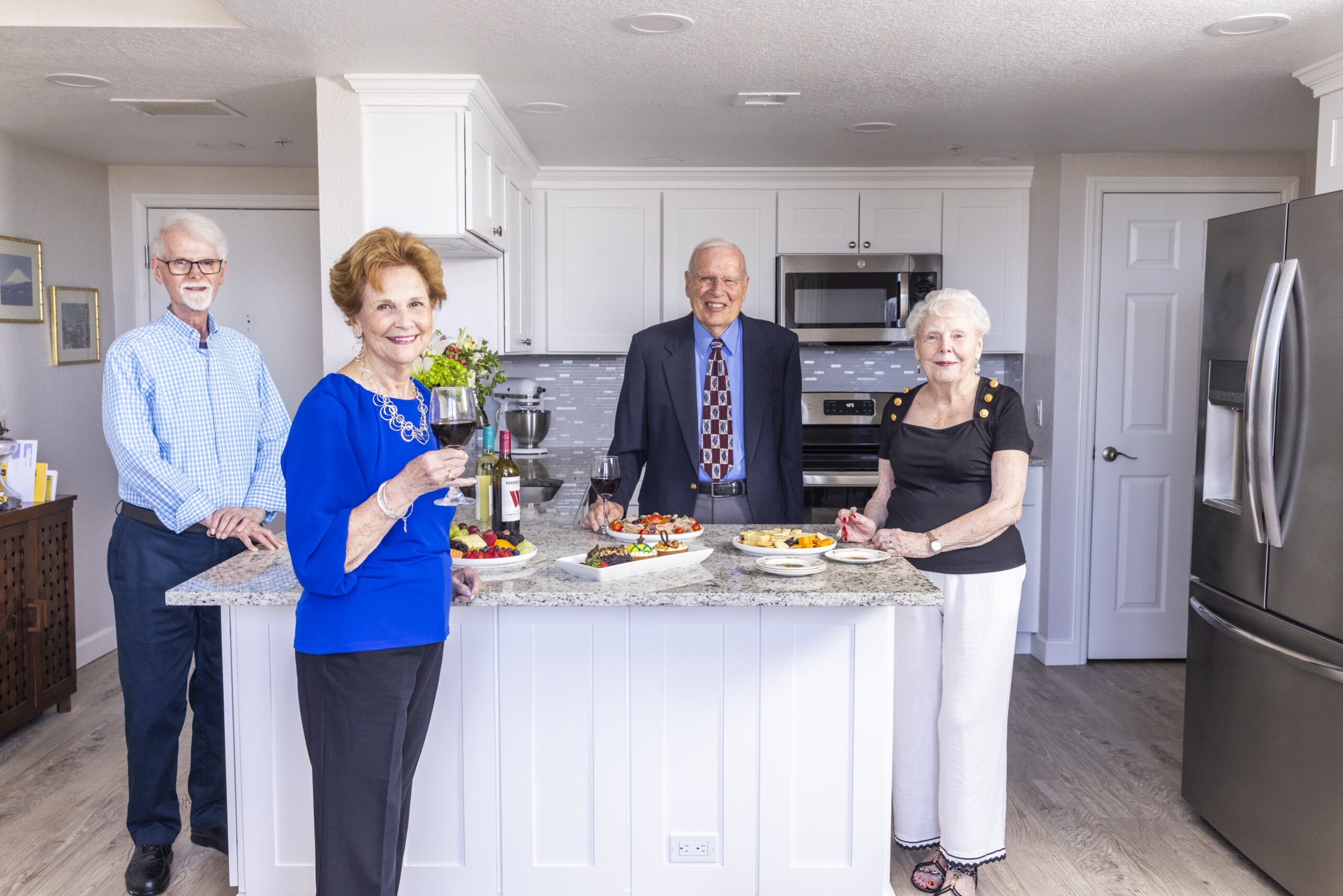 Residents enjoying appetizers in a kitchen setting