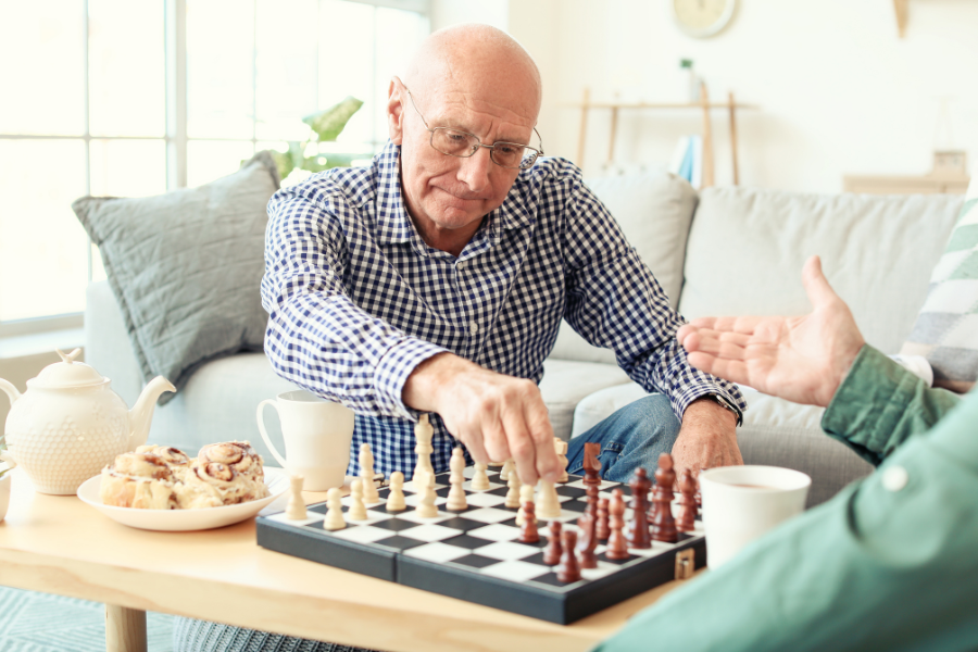 Residents enjoying a game of chess with snacks