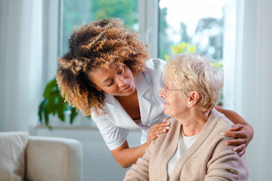 Caregiver assisting a resident in a bright room