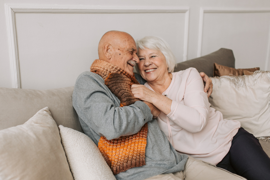 A couple sharing a joyful moment on a sofa