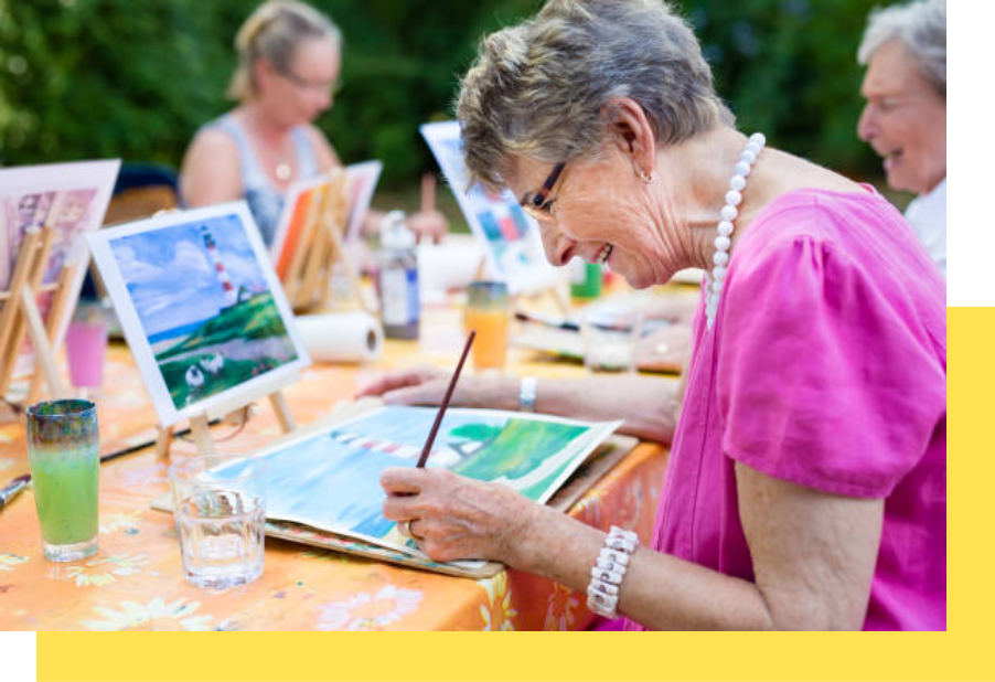 Residents participating in an outdoor painting activity