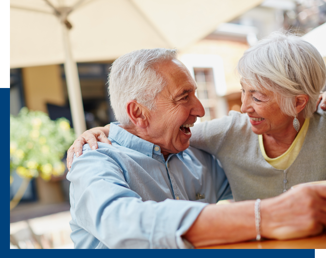 Two seniors enjoying a joyful moment outdoors