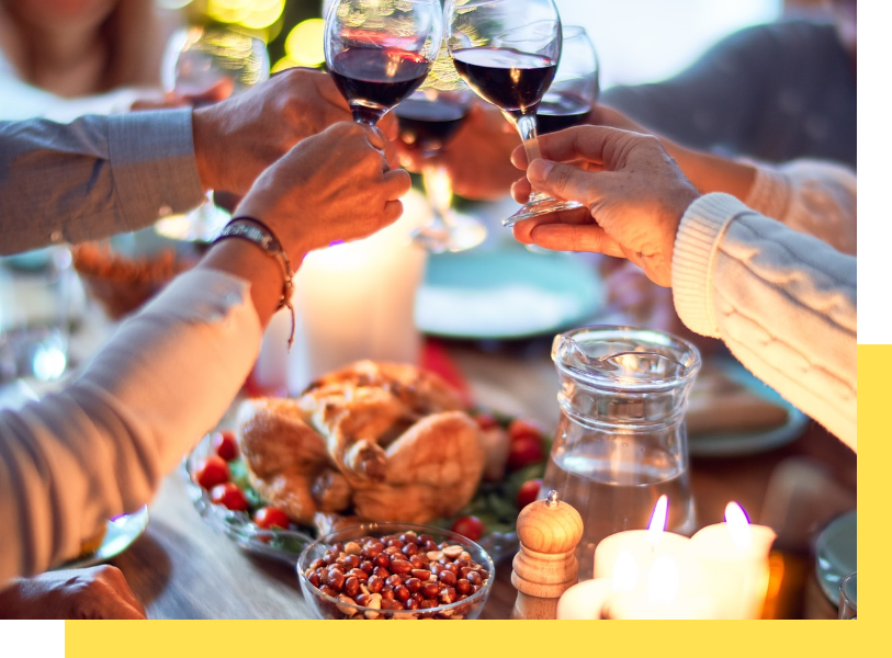 A group celebration with toasts and food on the table