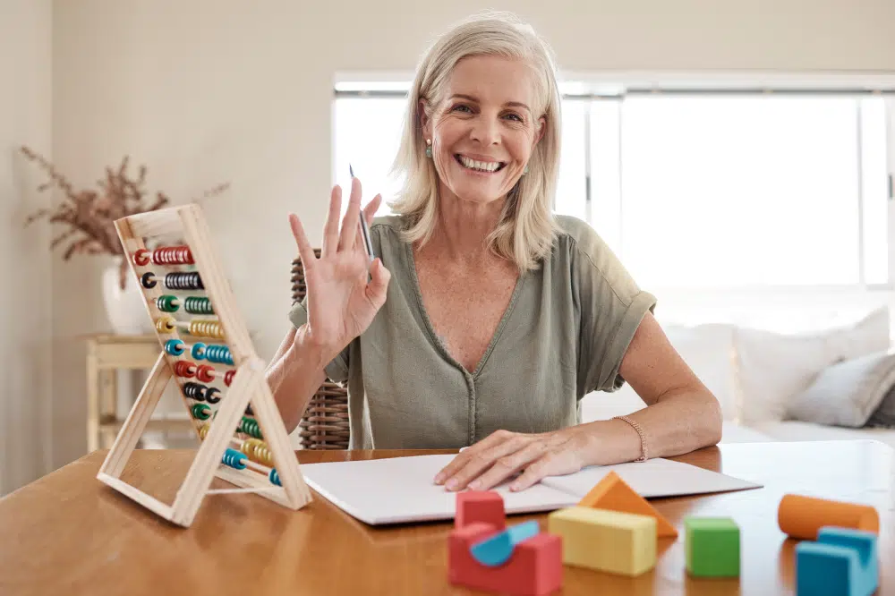 A smiling resident engaged in an activity with blocks