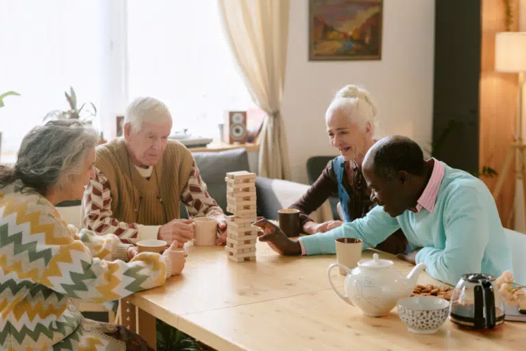 Residents playing Jenga in a common area